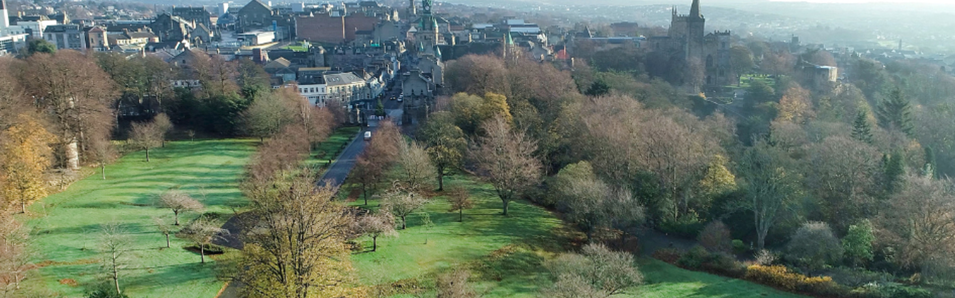 Image of historic town with parkland in the foreground.