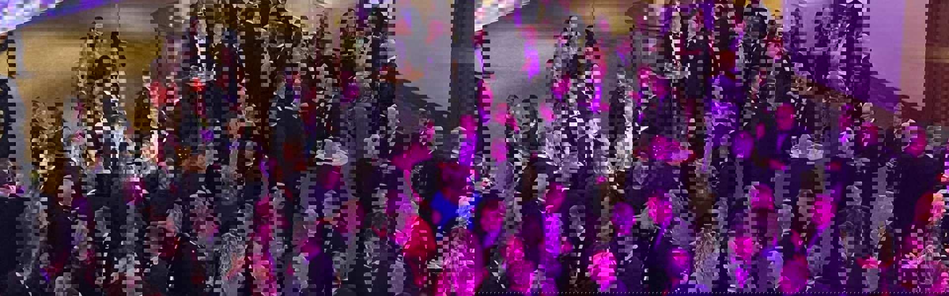 People meeting in the foyer of a dinner event.