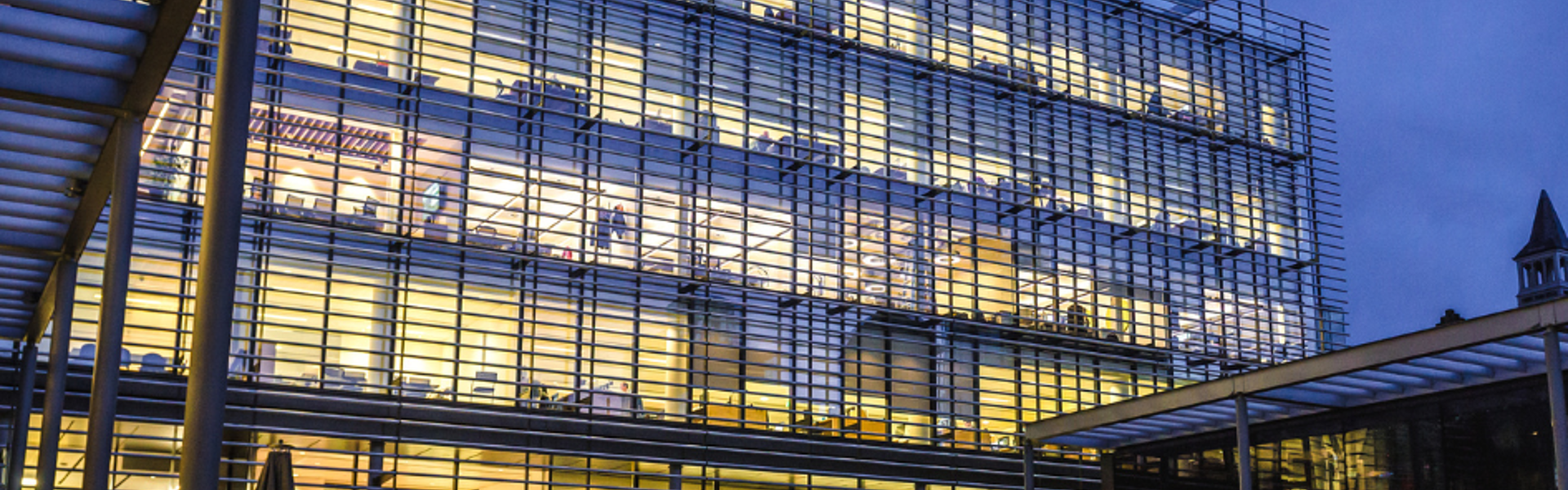 View of modern office building at dusk.